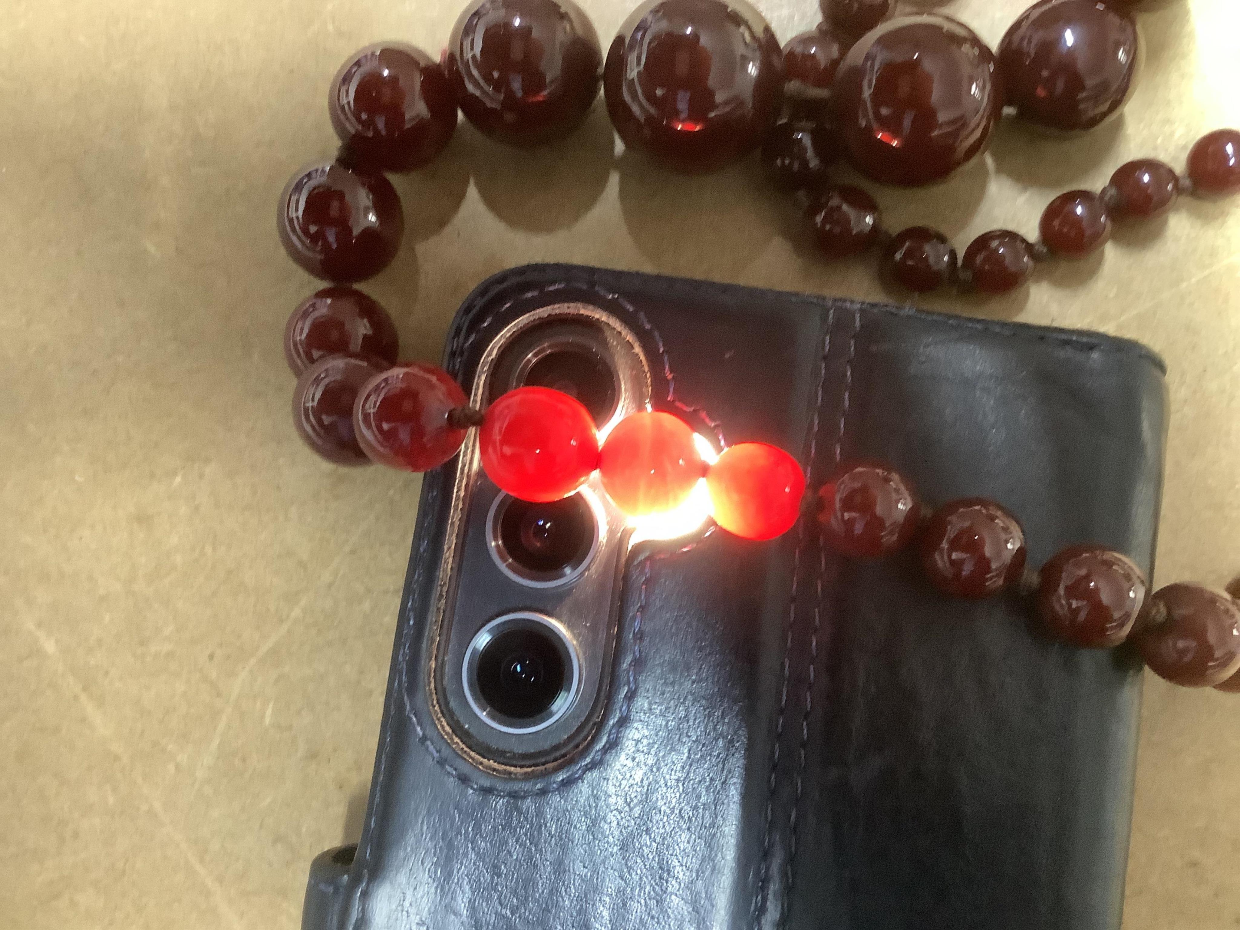 A cherry bakelite 'amber' necklace, composed of graduated spherical beads measuring approximately 6.7-23mm diameter, length approximately 86cm, gross weight 72 grams.